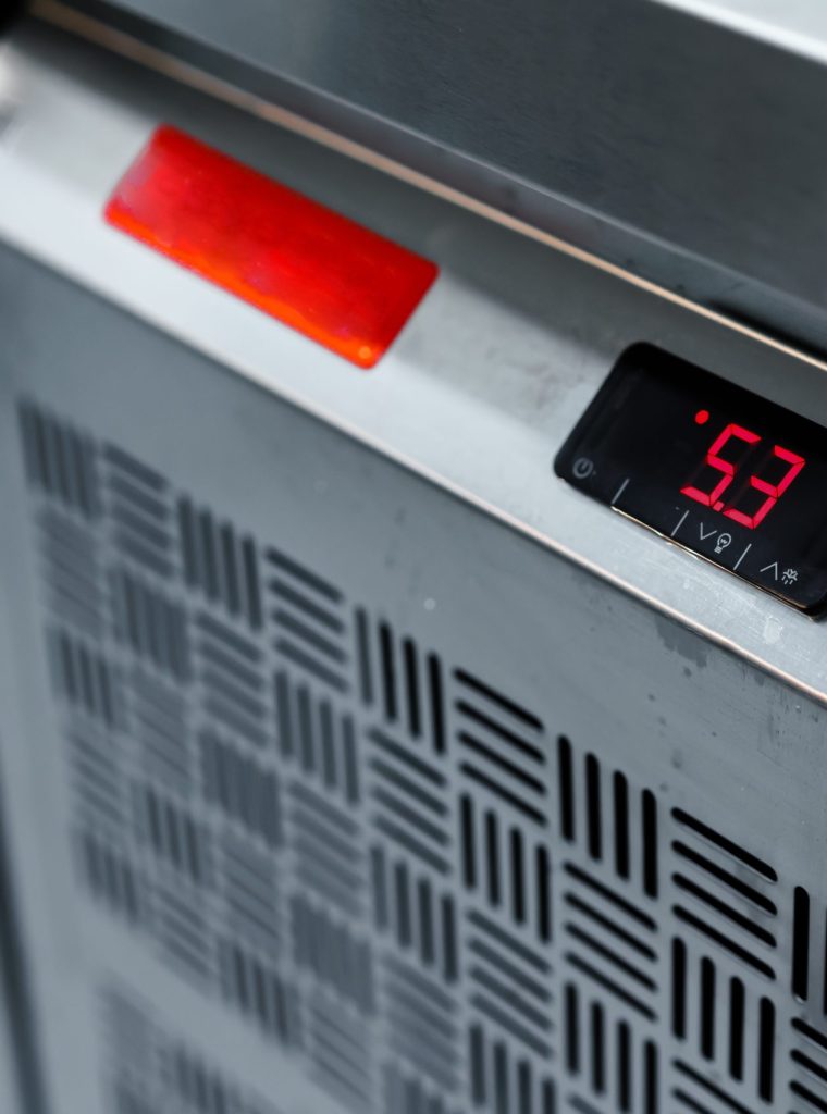 Commercial kitchen appliance temperature controls close up photo